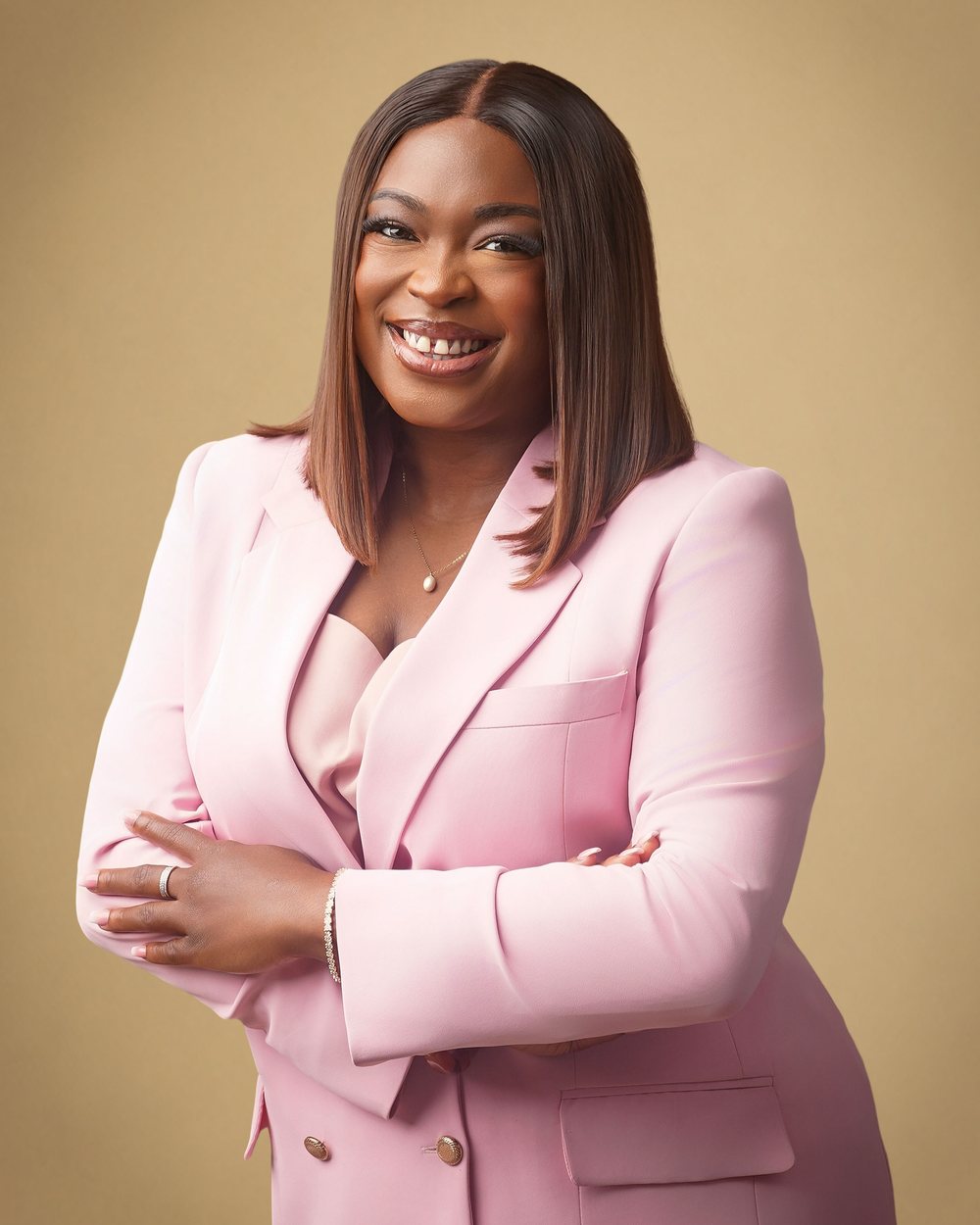 Altura's founder, smiling, in a pink suit
